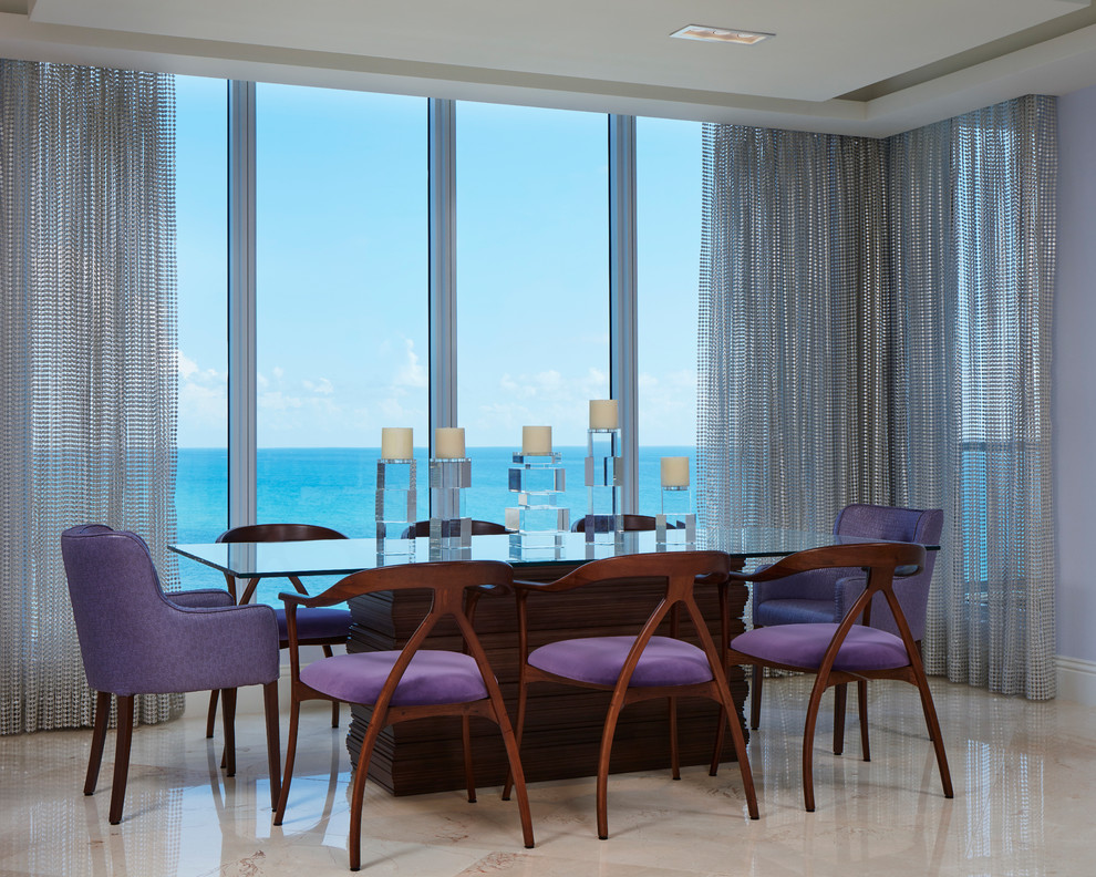 Photo of a large modern dining room in Miami with purple walls, marble flooring and beige floors.