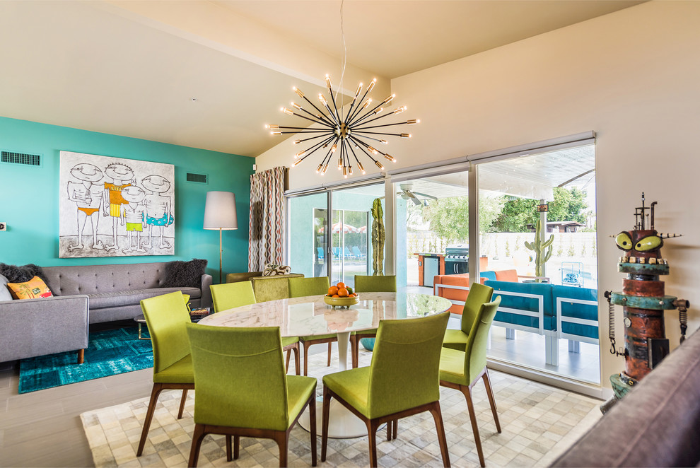 Photo of a midcentury dining room in Portland with beige walls, grey floors and feature lighting.