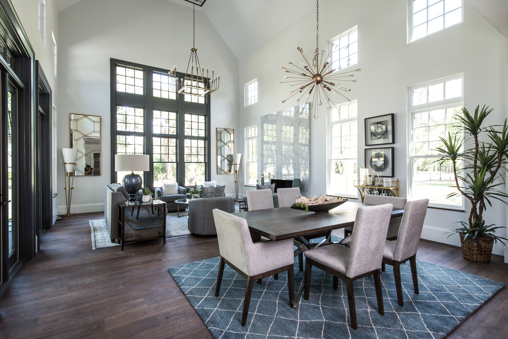 Medium sized classic open plan dining room in Charleston with a standard fireplace, a stone fireplace surround, white walls, dark hardwood flooring, brown floors and feature lighting.
