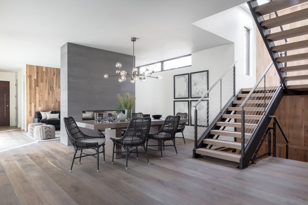 Photo of a contemporary open plan dining room in San Francisco with white walls, dark hardwood flooring and brown floors.
