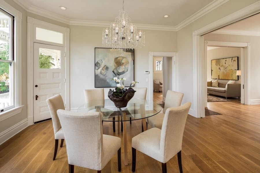 This is an example of a medium sized victorian kitchen/dining room in San Francisco with beige walls and light hardwood flooring.