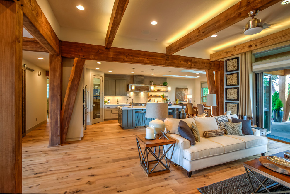 Inspiration for a large rustic kitchen/dining room in Portland with beige walls, light hardwood flooring, brown floors and feature lighting.