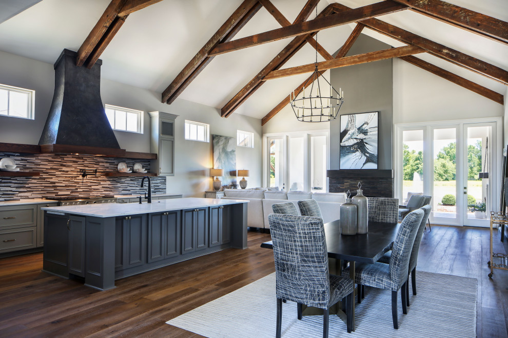 Exemple d'une grande salle à manger ouverte sur le salon chic avec un mur blanc, un sol en bois brun, une cheminée standard, un manteau de cheminée en bois, un sol marron et un plafond voûté.