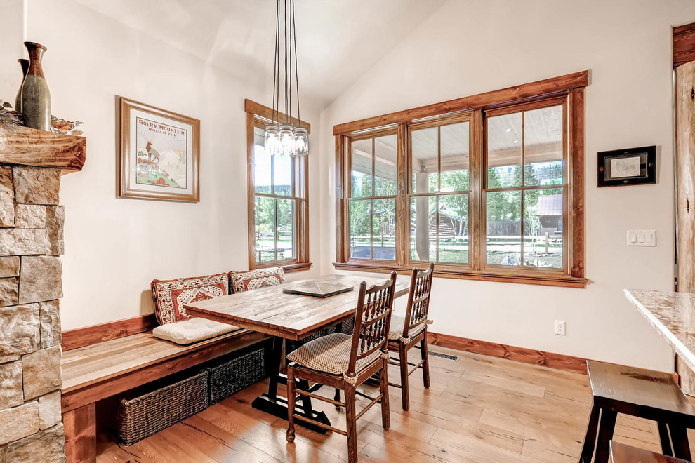 Inspiration for a small traditional open plan dining room in Denver with medium hardwood flooring.