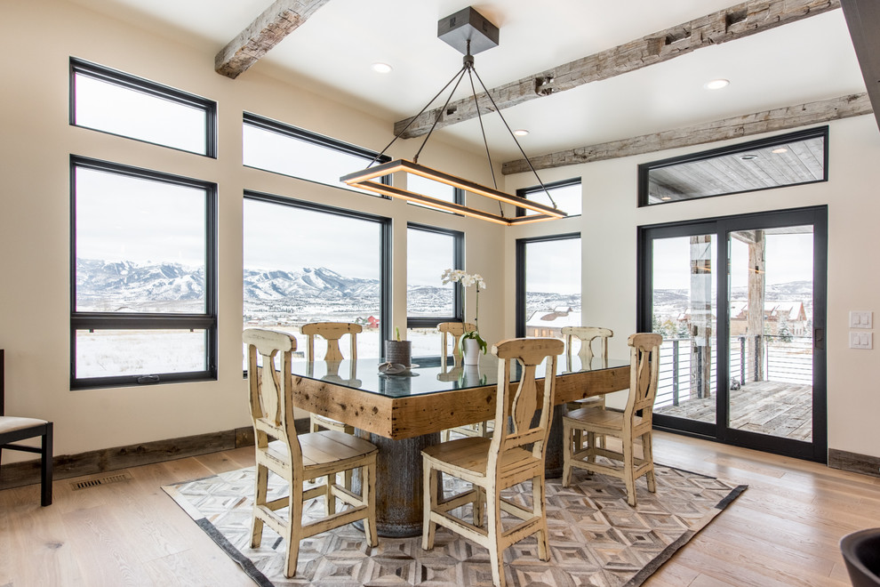 Rustic dining room in Salt Lake City with beige walls and light hardwood flooring.