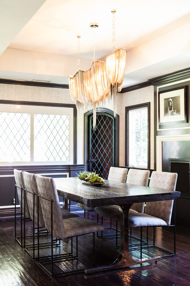 Photo of a traditional dining room in Los Angeles with white walls and dark hardwood flooring.