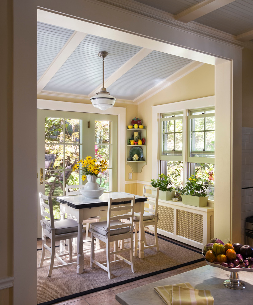 This is an example of a traditional dining room in New York with yellow walls.