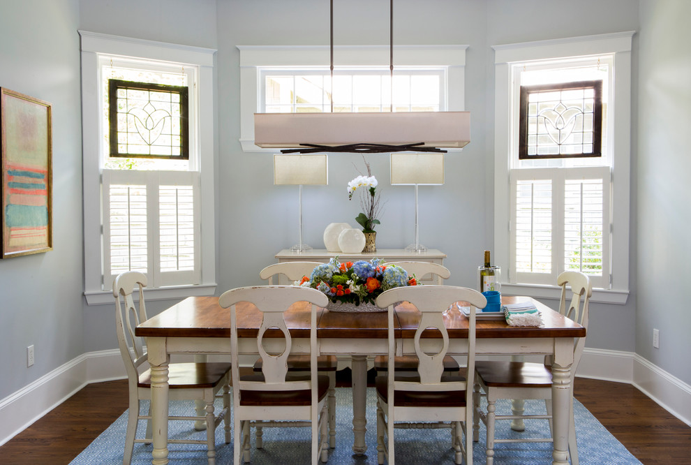 Elegant dark wood floor dining room photo in Charlotte with blue walls