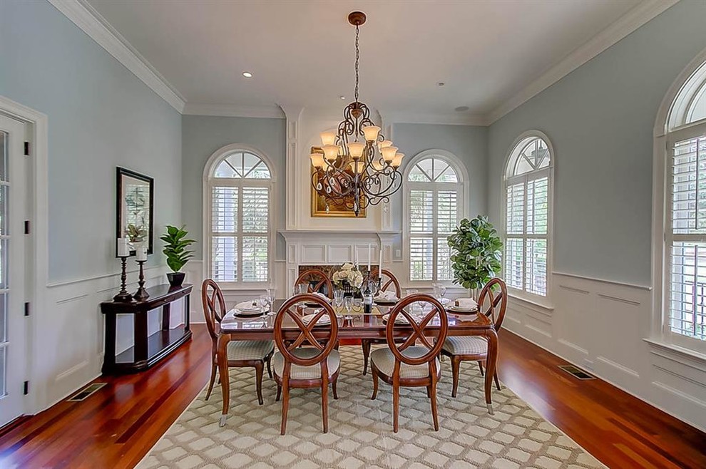 Design ideas for a large classic enclosed dining room in Charleston with blue walls, dark hardwood flooring, no fireplace and brown floors.