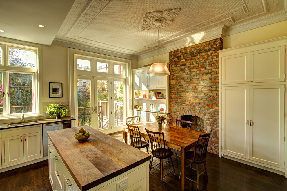 Kitchen/dining room combo - traditional brown floor kitchen/dining room combo idea in New York