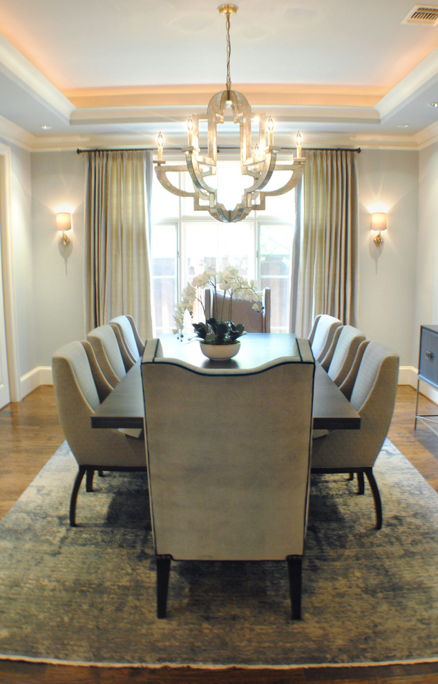 Photo of a medium sized traditional enclosed dining room in Dallas with grey walls, medium hardwood flooring, no fireplace and brown floors.
