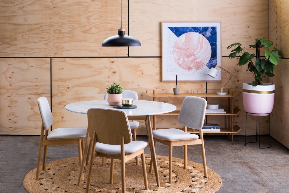 На фото: столовая среднего размера в скандинавском стиле с бежевыми стенами, бетонным полом и коричневым полом без камина с
