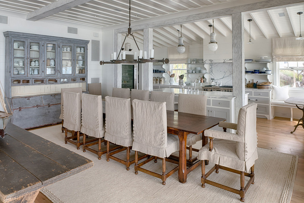 Photo of a beach style dining room in Charleston with white walls, medium hardwood flooring and brown floors.