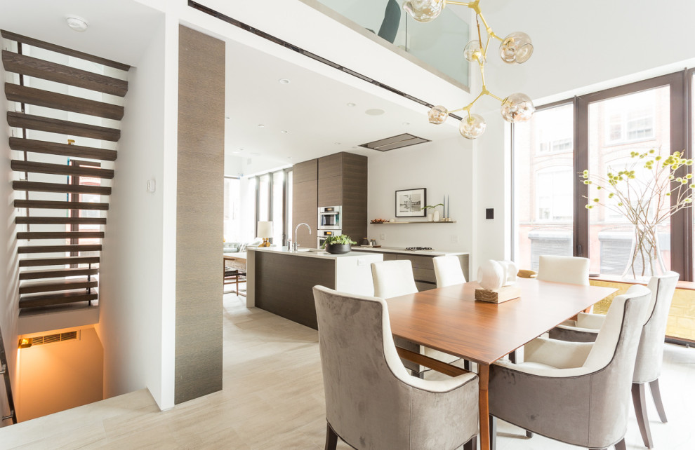 Esempio di una sala da pranzo aperta verso il soggiorno contemporanea con pareti bianche, nessun camino e pavimento beige