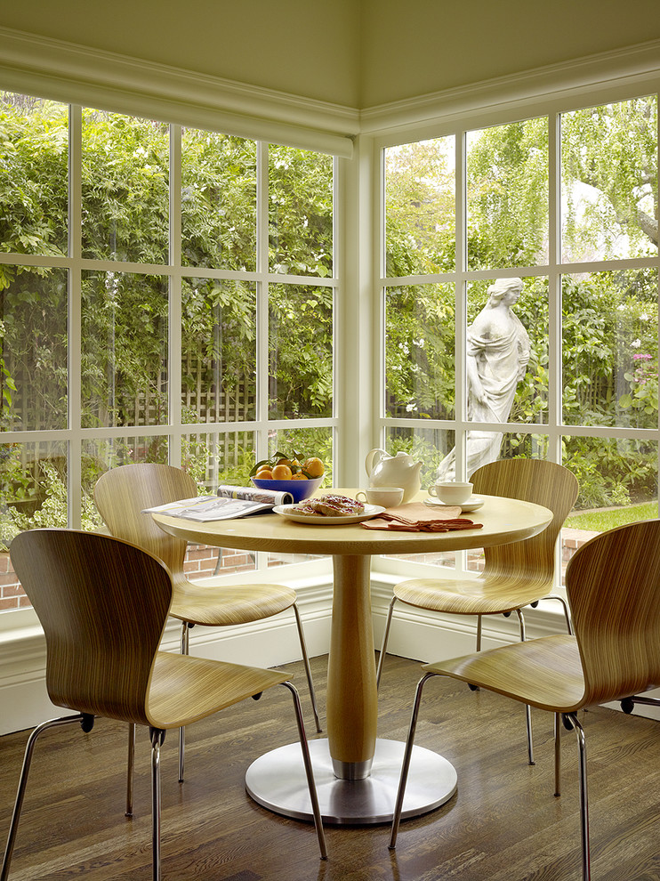 This is an example of a contemporary dining room in San Francisco with beige walls and dark hardwood flooring.