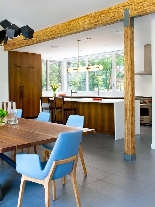 This is an example of a modern open plan dining room in New York with porcelain flooring.