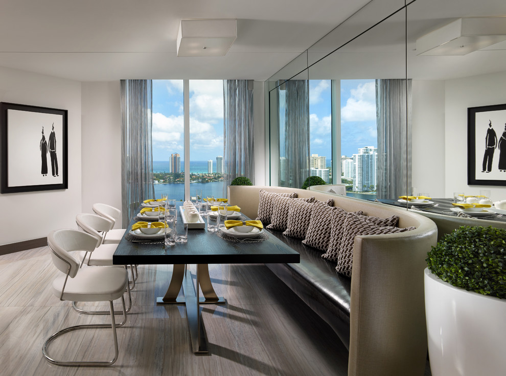 Photo of a contemporary dining room in Miami with white walls and no fireplace.