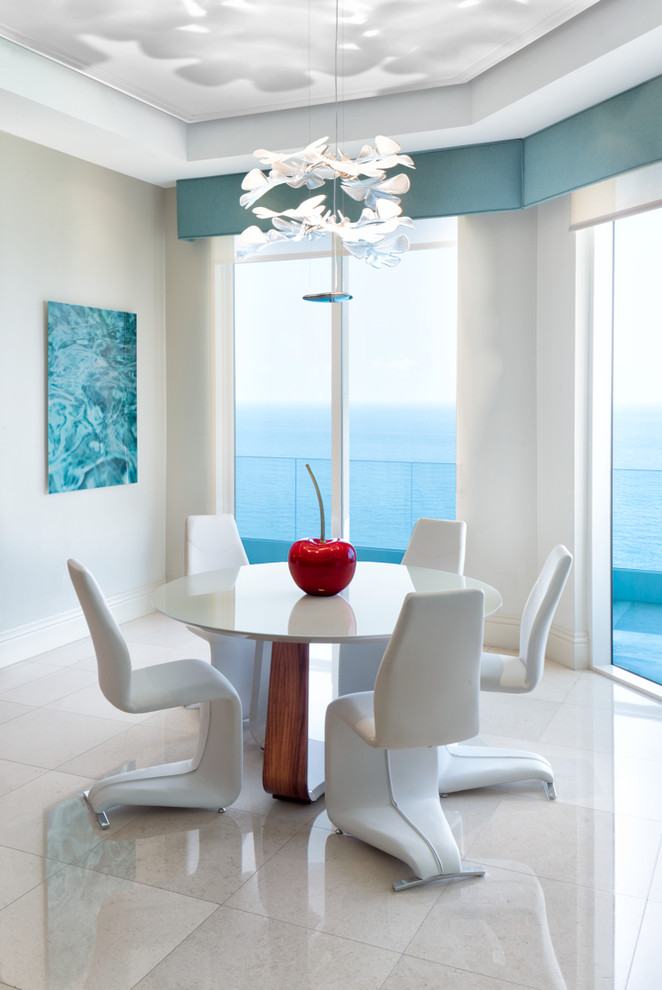 Design ideas for a small coastal dining room in Miami with marble flooring, grey walls, no fireplace and beige floors.