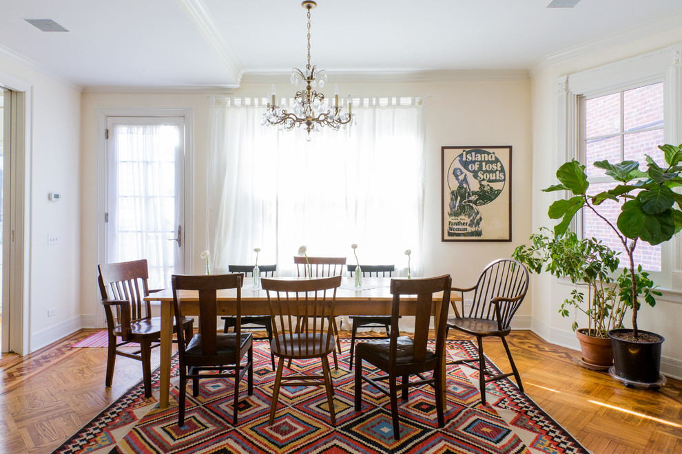 Large eclectic medium tone wood floor dining room photo in New York with white walls, a standard fireplace and a stone fireplace