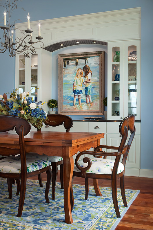 Photo of a nautical dining room in Grand Rapids with blue walls, medium hardwood flooring, no fireplace and brown floors.