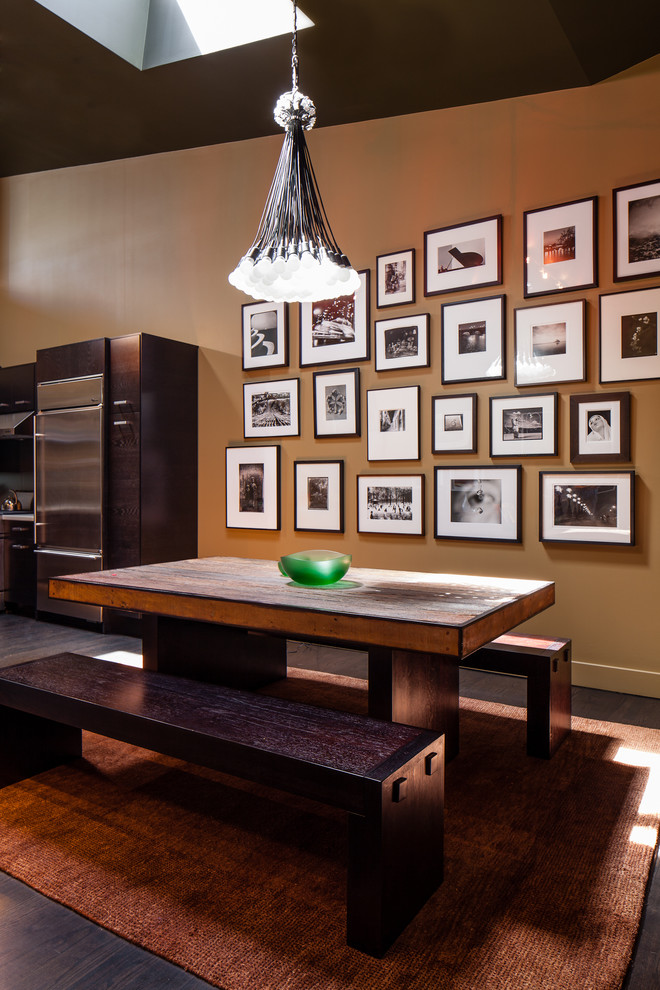 This is an example of a contemporary dining room in San Francisco with brown walls and dark hardwood flooring.