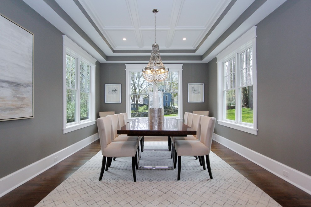 Classic dining room in New York with grey walls, dark hardwood flooring and brown floors.