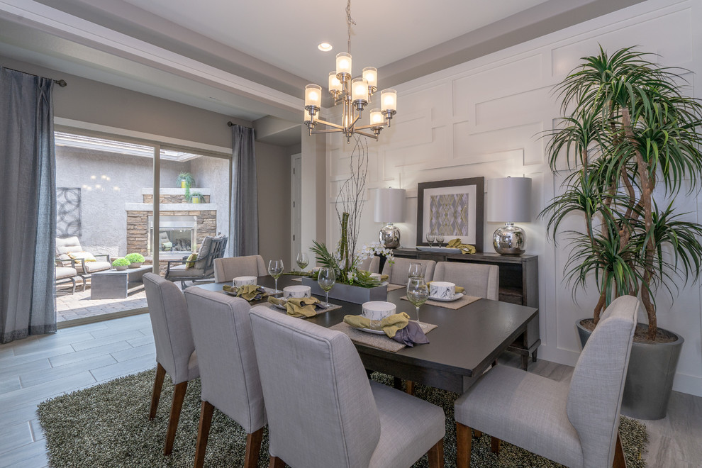 Inspiration for a medium sized contemporary open plan dining room in Phoenix with white walls, ceramic flooring and grey floors.