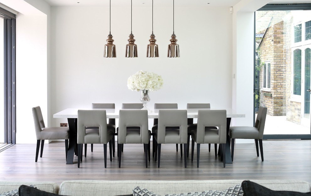 Ispirazione per una sala da pranzo aperta verso il soggiorno design con pareti bianche
