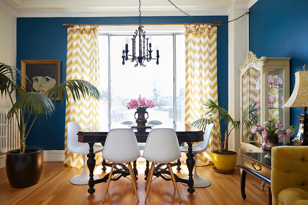 Dining room - small eclectic light wood floor dining room idea in Boston with blue walls