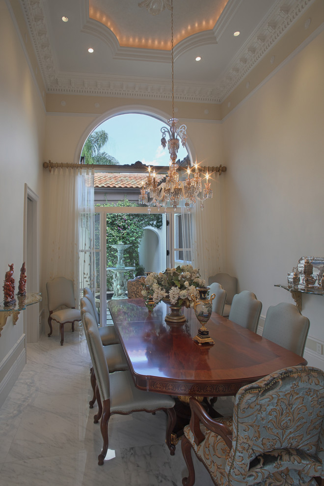 Inspiration for a large mediterranean marble floor enclosed dining room remodel in Miami with beige walls
