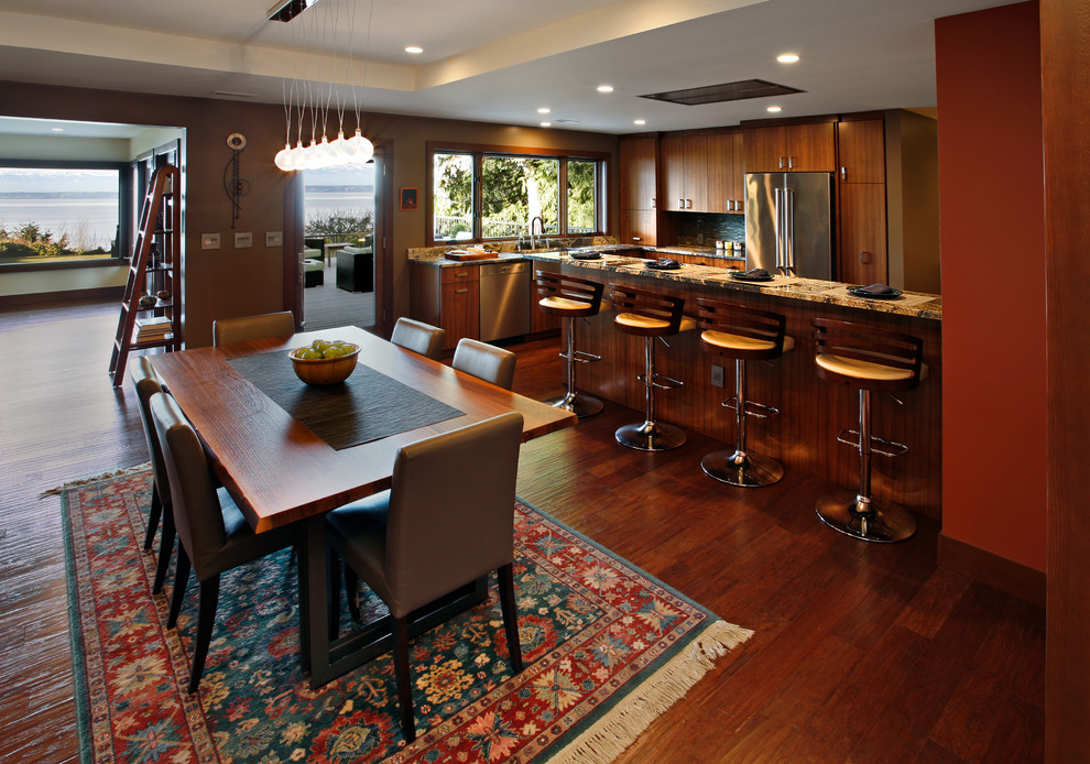 Medium sized traditional kitchen/dining room in Seattle with orange walls and dark hardwood flooring.