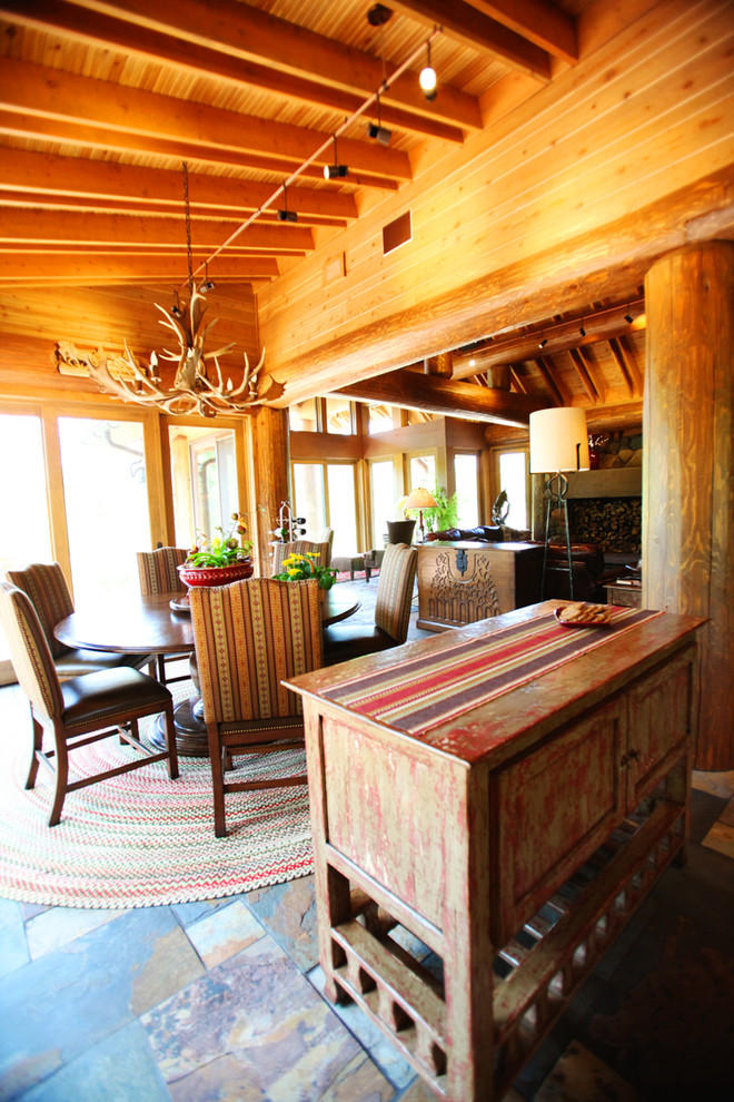This is an example of a large rustic open plan dining room in Minneapolis with slate flooring and no fireplace.