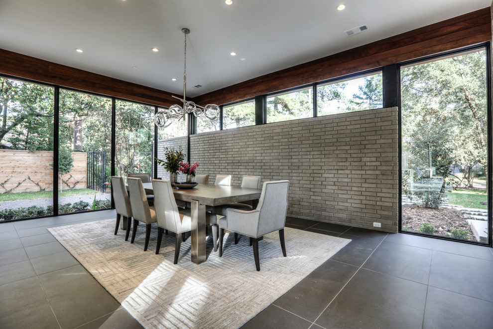 Large modern enclosed dining room in Houston with porcelain flooring and grey floors.