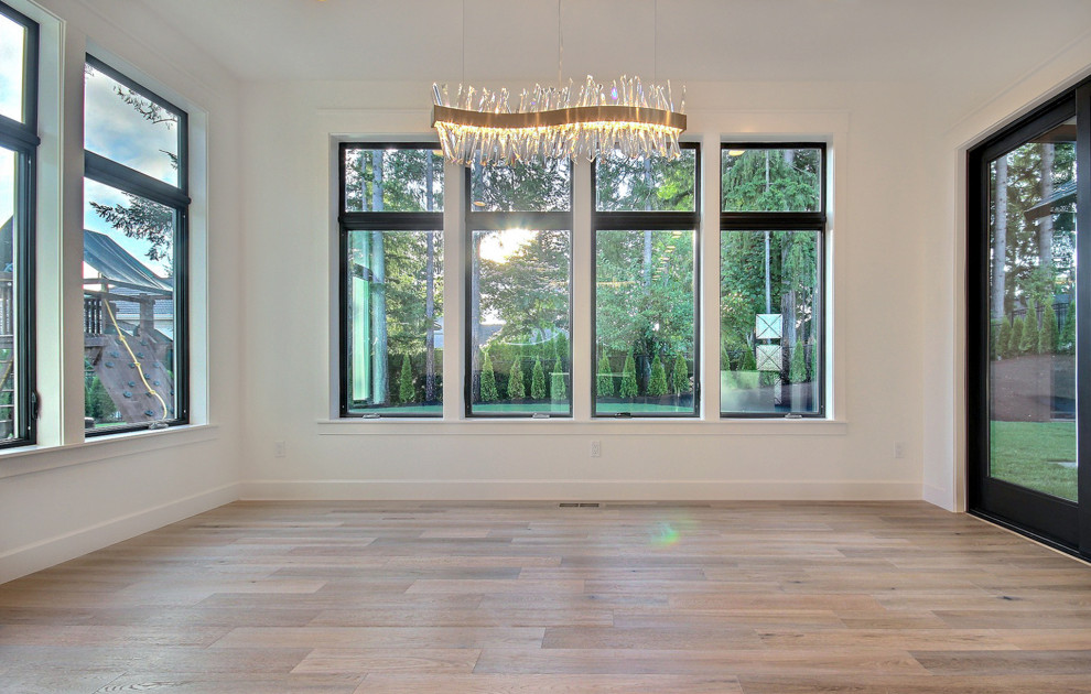 Example of a huge country light wood floor and beige floor great room design in Portland with white walls