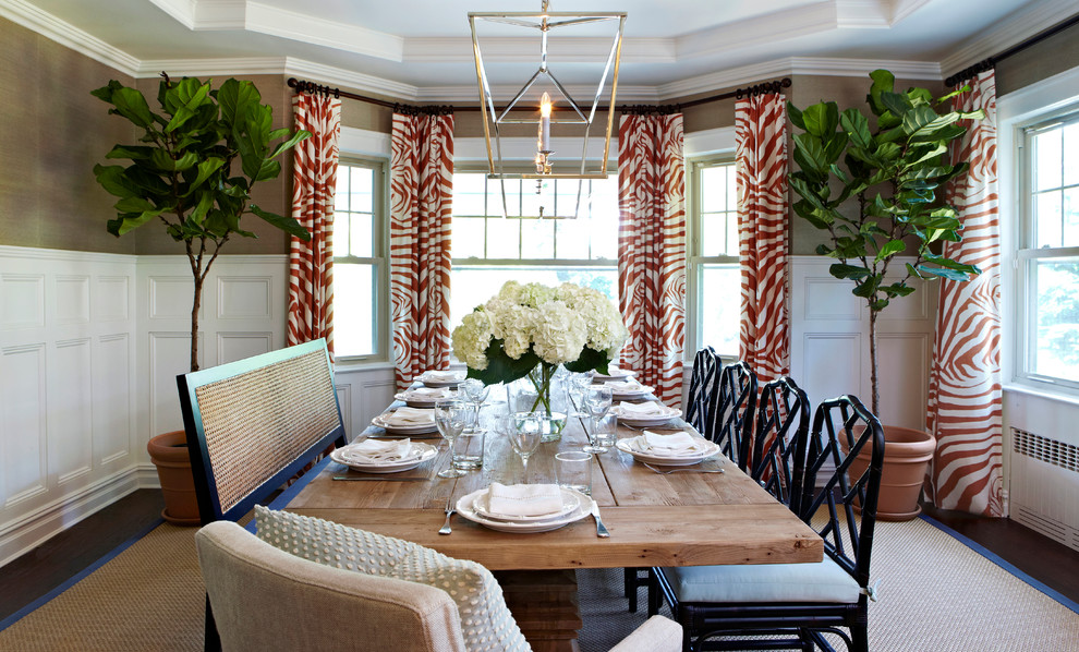 This is an example of a large classic enclosed dining room in New York with metallic walls, dark hardwood flooring and no fireplace.