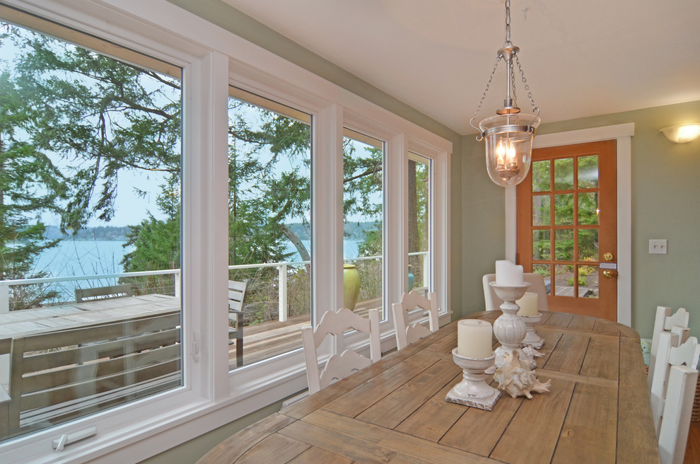 Photo of a medium sized beach style open plan dining room in Seattle with light hardwood flooring.