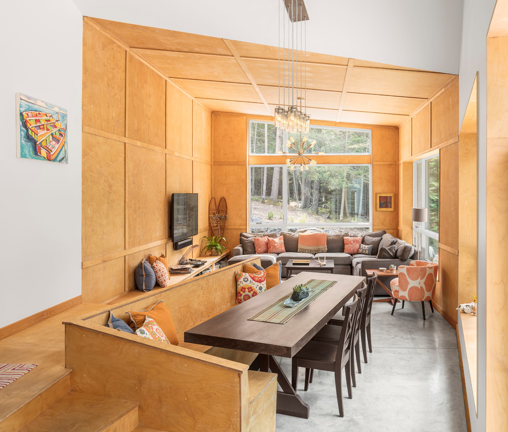 Idées déco pour une salle à manger ouverte sur le salon montagne avec un mur marron, sol en béton ciré et un sol gris.
