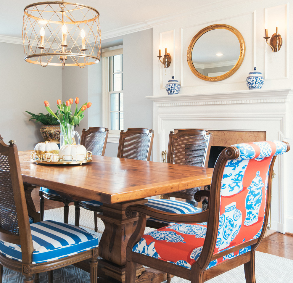 Photo of a classic enclosed dining room in Philadelphia with grey walls, dark hardwood flooring, a standard fireplace and a stone fireplace surround.