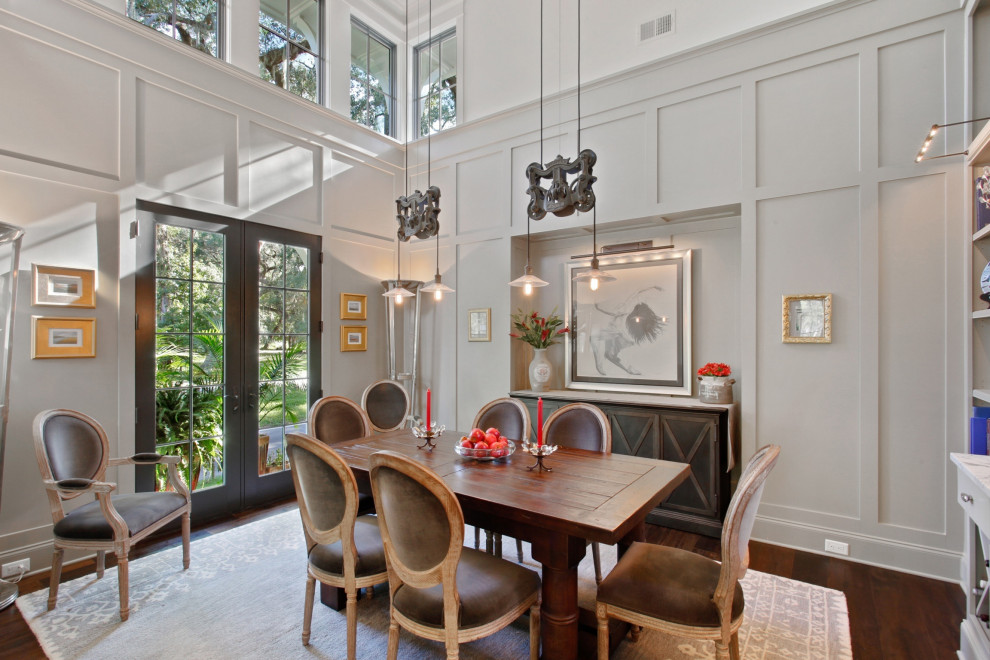 Large traditional dining room in Charleston with grey walls, medium hardwood flooring and brown floors.