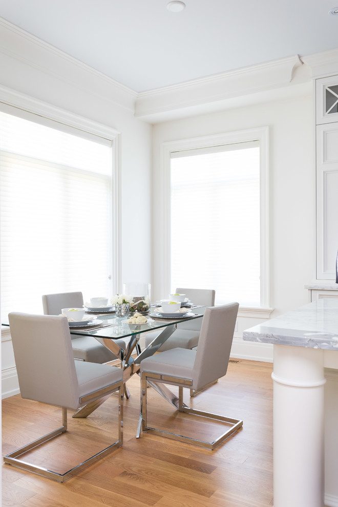 Dining room - traditional light wood floor dining room idea in Toronto with white walls
