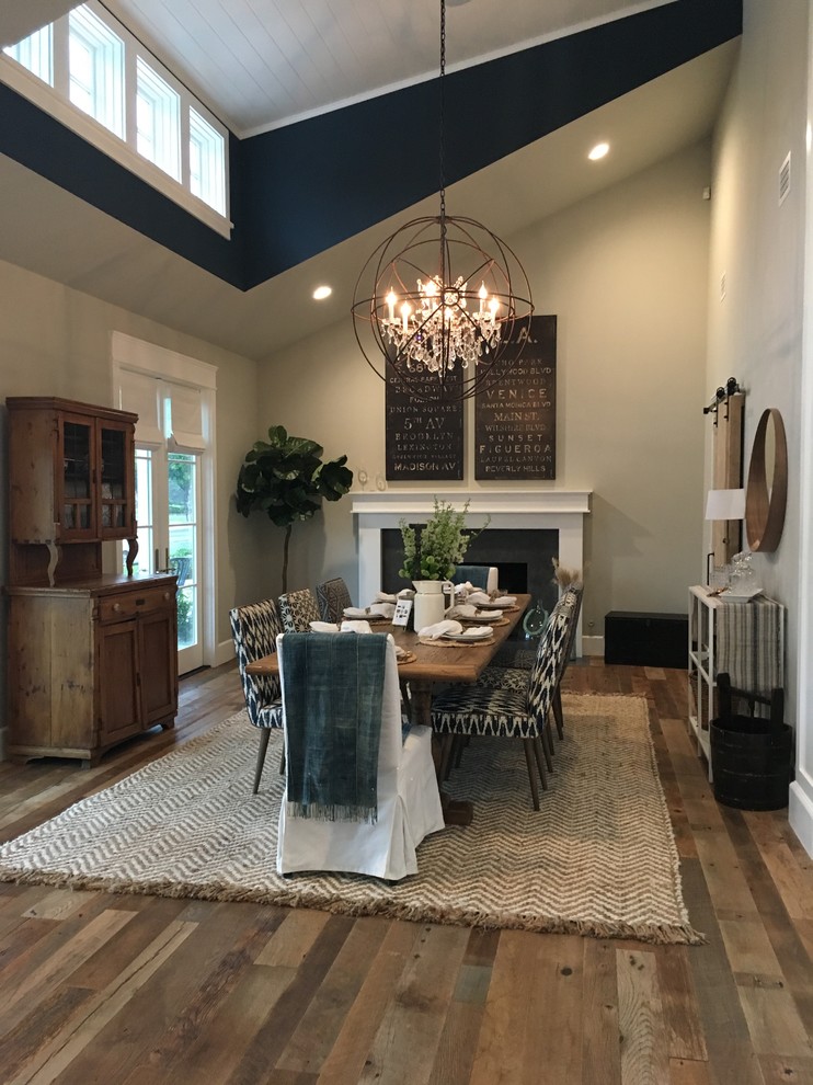 Inspiration for a coastal dining room in Orange County with grey walls, dark hardwood flooring and a standard fireplace.
