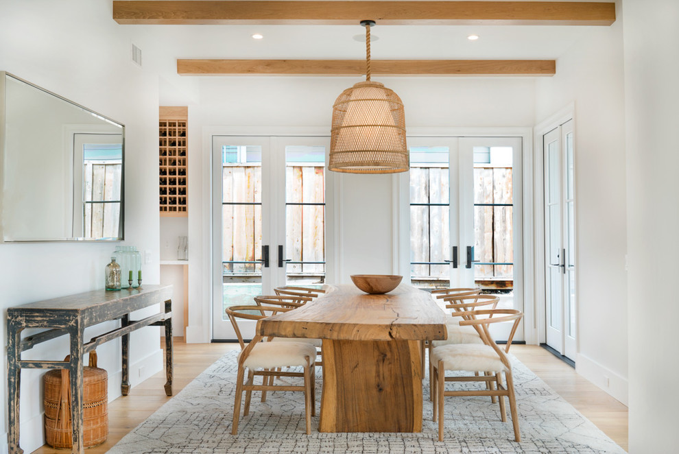 Dining room - coastal medium tone wood floor and brown floor dining room idea in Orange County with white walls