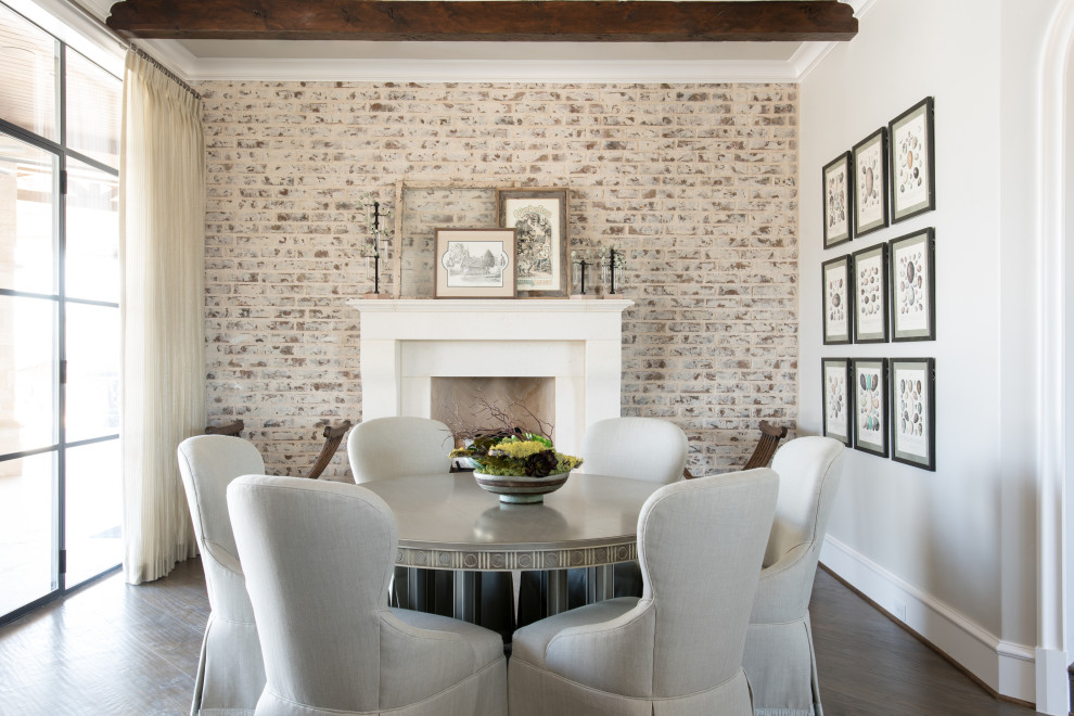 Example of a mid-sized french country dark wood floor, brown floor, exposed beam and brick wall breakfast nook design in Dallas with gray walls, a standard fireplace and a stone fireplace