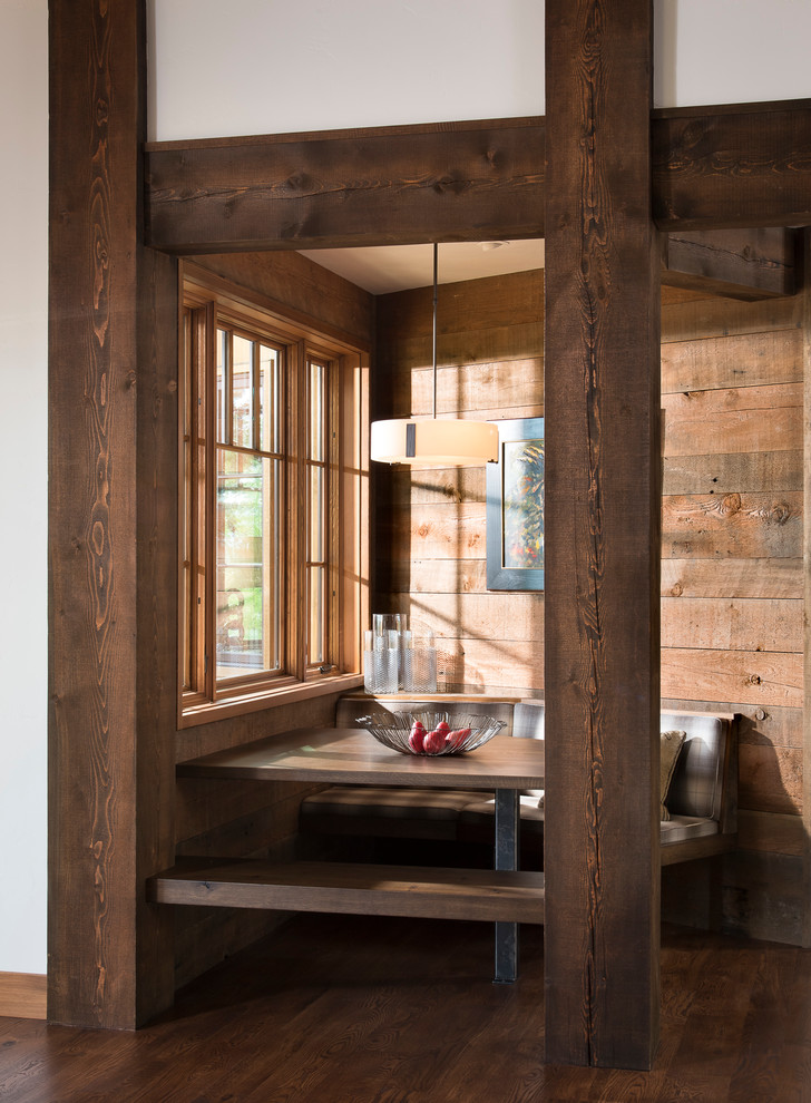 This is an example of a rustic dining room in Other with brown walls, dark hardwood flooring and brown floors.