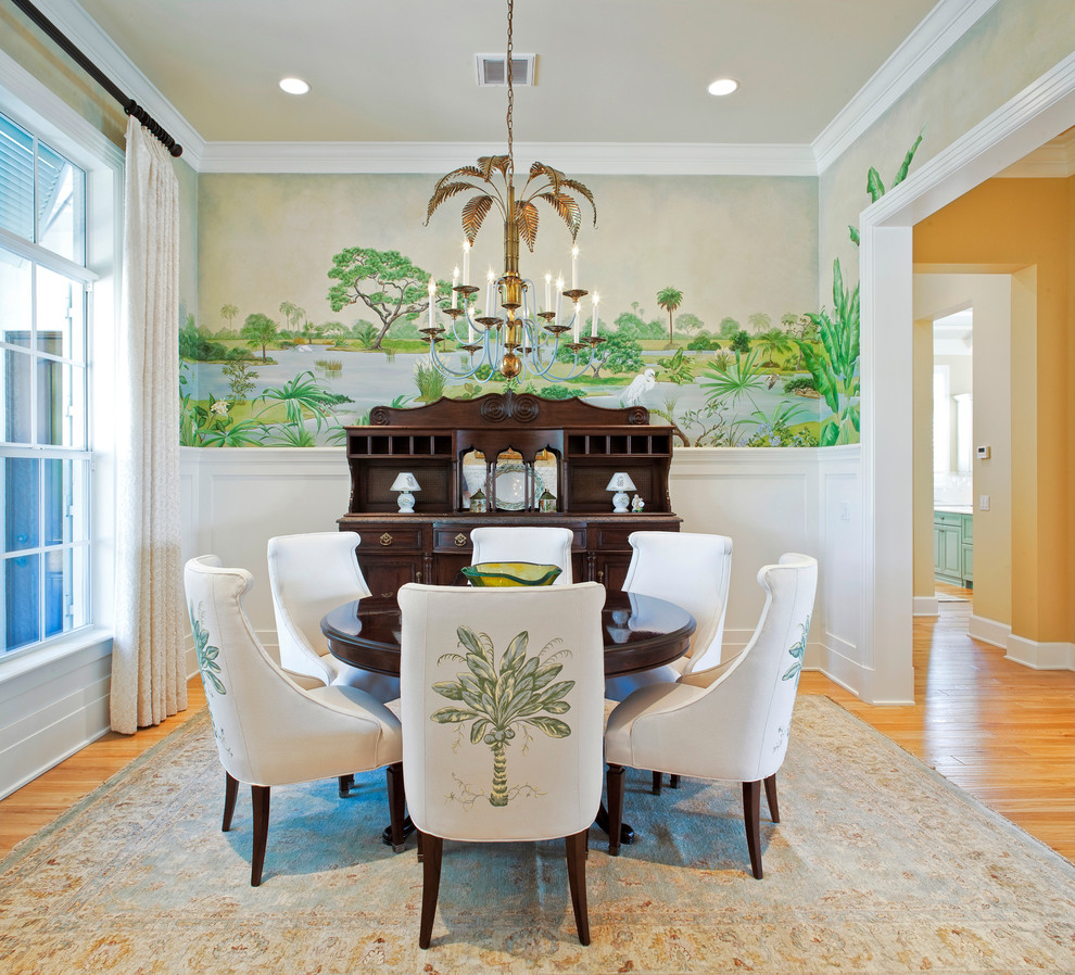 Design ideas for a world-inspired enclosed dining room in Orlando with multi-coloured walls and medium hardwood flooring.