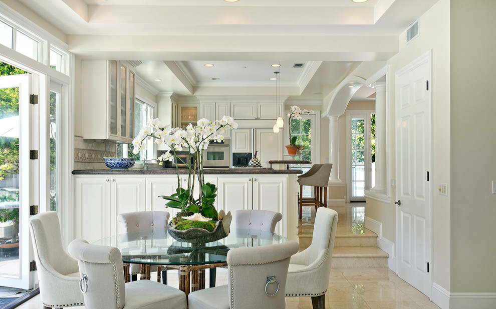 Photo of a classic open plan dining room in Orange County with beige walls.