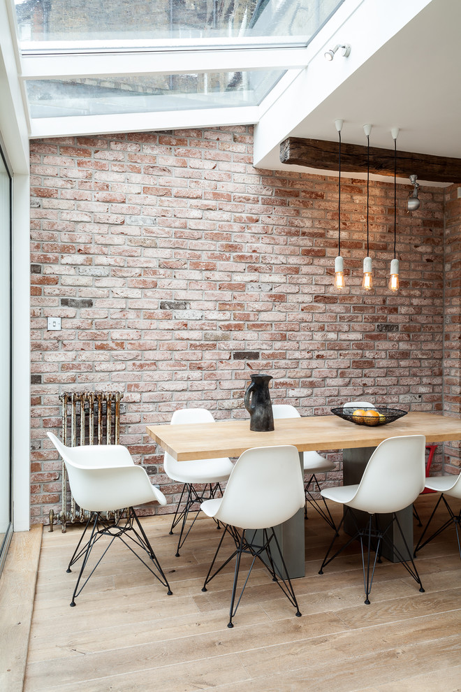 Design ideas for an urban dining room in London with feature lighting.
