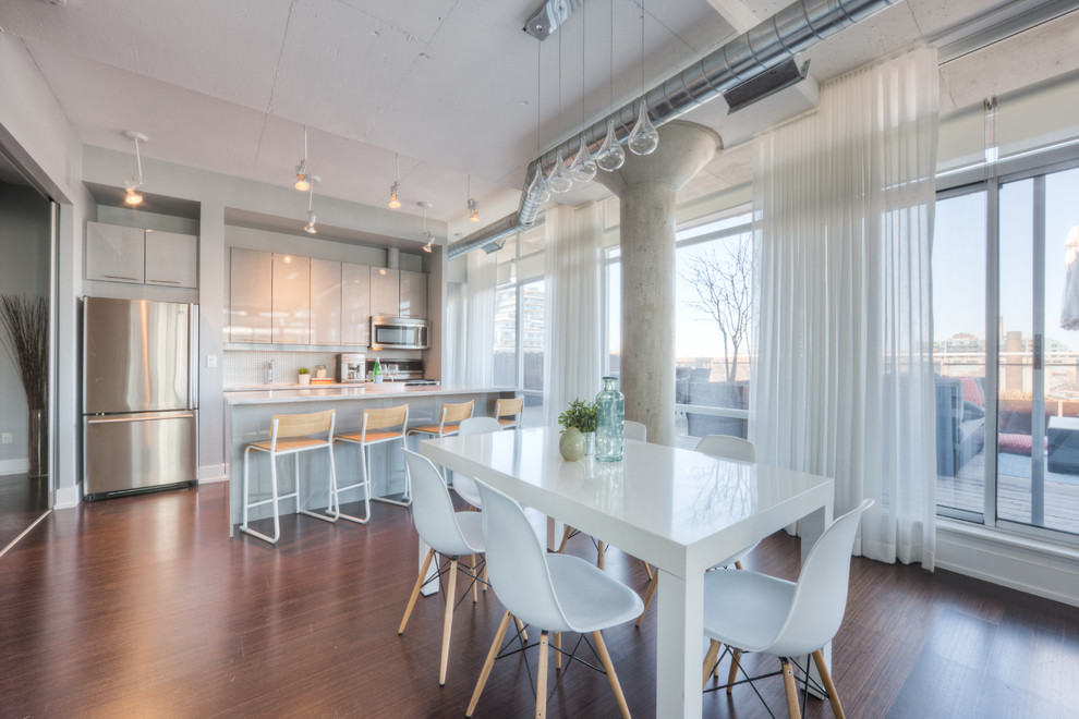 Photo of a medium sized urban open plan dining room in Toronto with white walls, medium hardwood flooring, no fireplace and brown floors.