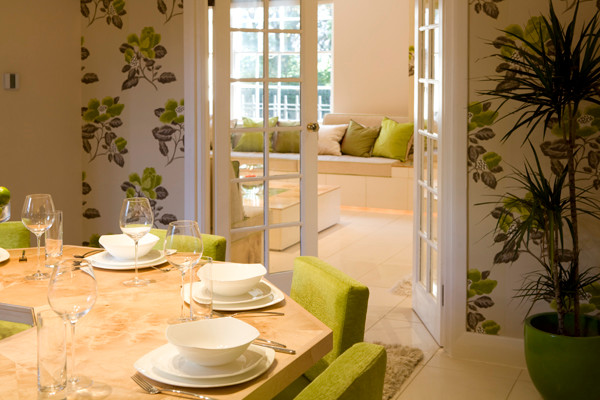 This is an example of a medium sized traditional enclosed dining room in London with beige walls and porcelain flooring.