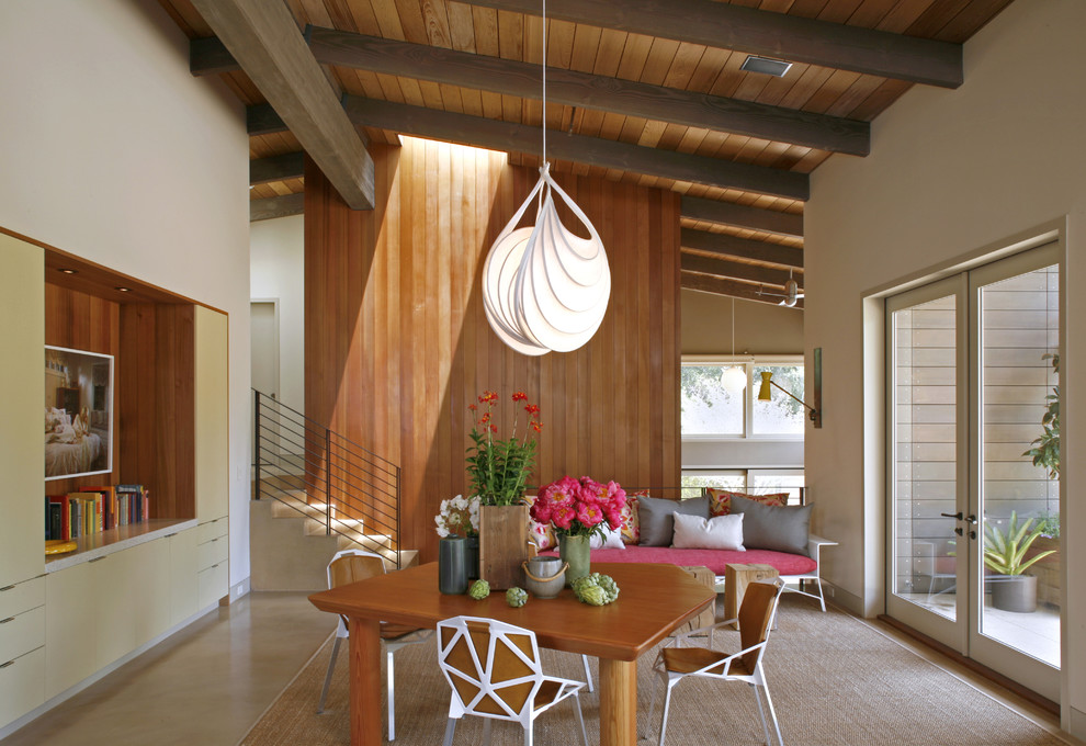 Example of a mid-century modern dining room design in San Francisco with white walls